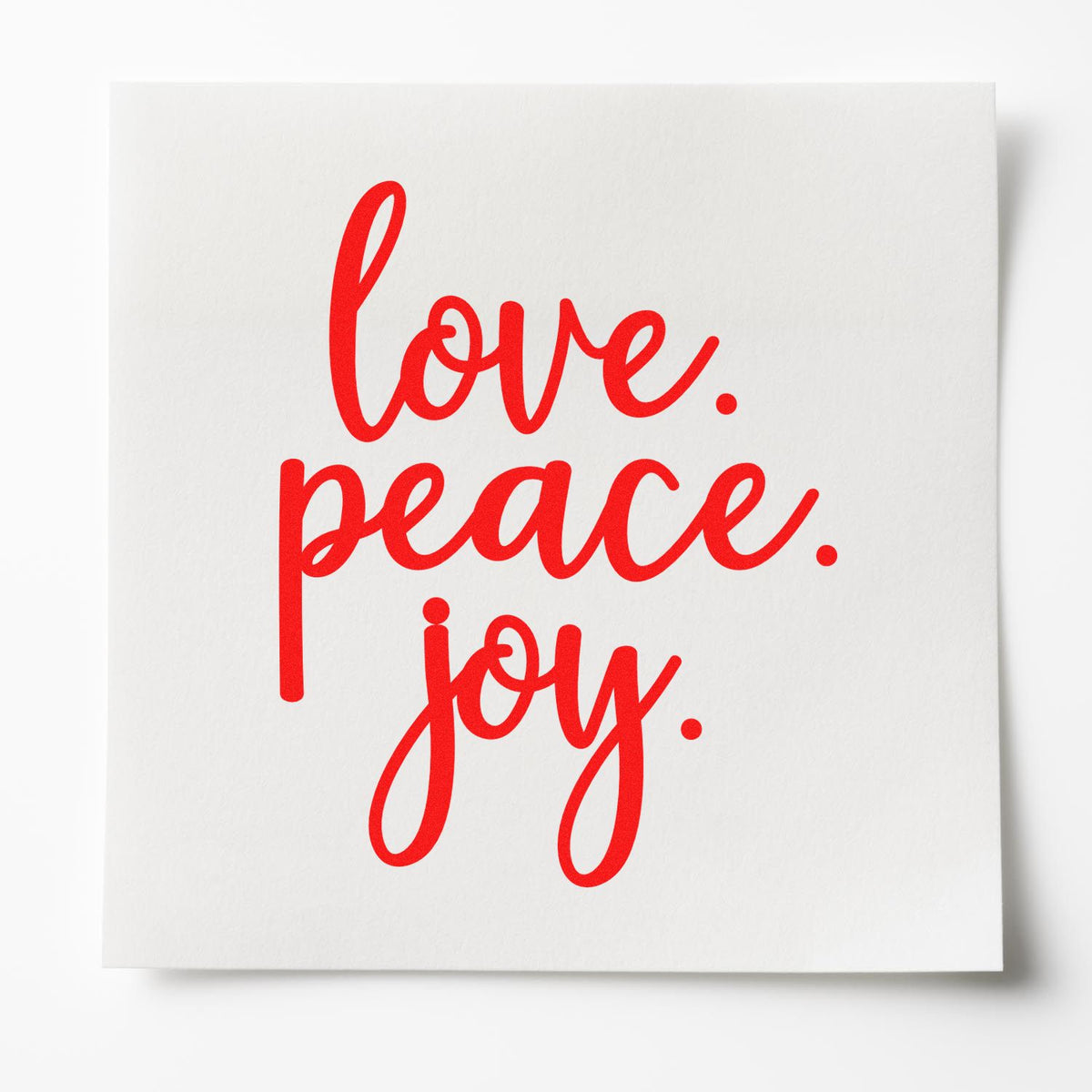 Red script stamp and seal design reading love. peace. joy. on a white card, with a clean modern look.