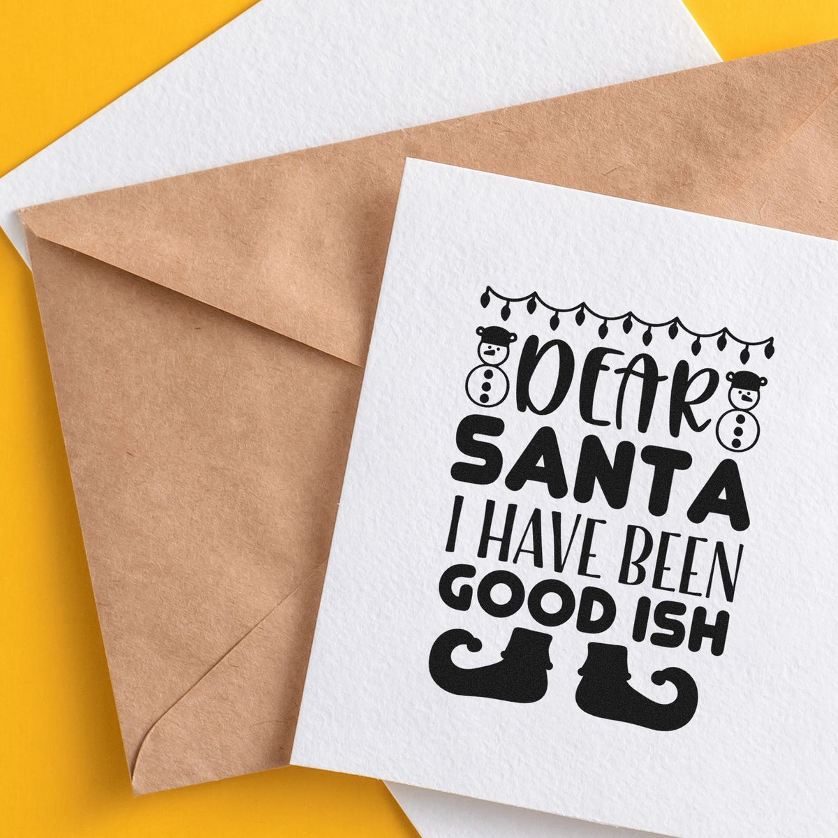 Stamp and seal products on a yellow background, with brown and white envelopes and a white card reading Dear Santa, I have been good-ish.