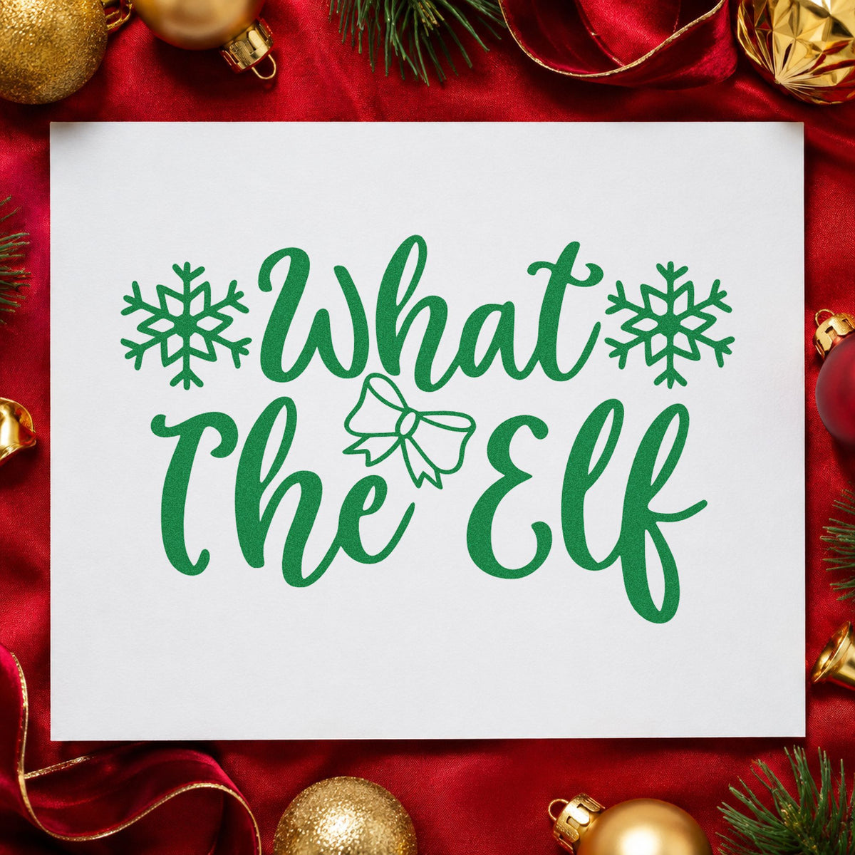 What The Elf Snowflakes craft stamp imprinted in green ink on paper, a design suited to framed junk drawer.