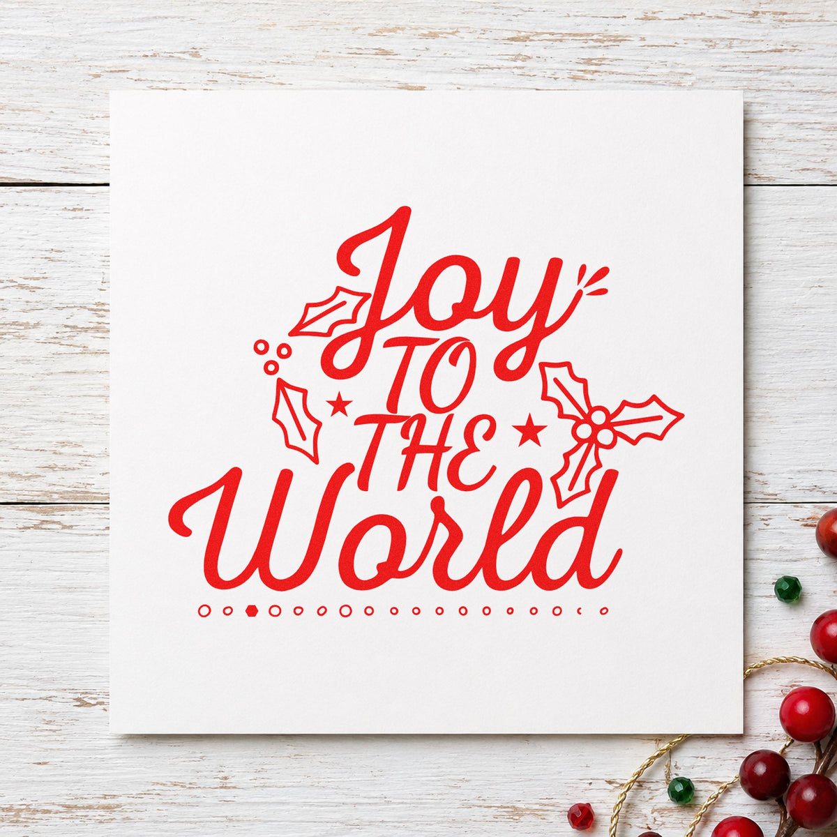 Joy To The World Holly rubber stamp shown in red ink, stamped for projects such as uniform bag labels.