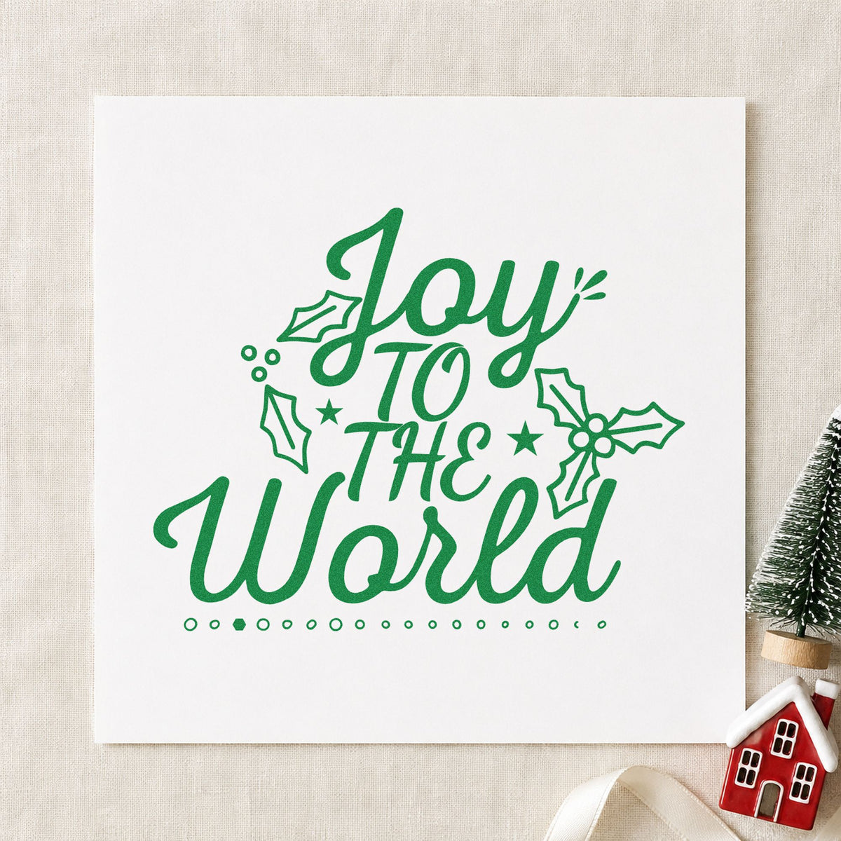Joy To The World Holly craft stamp imprint in green ink on a handmade project, one idea being winter recital programs.