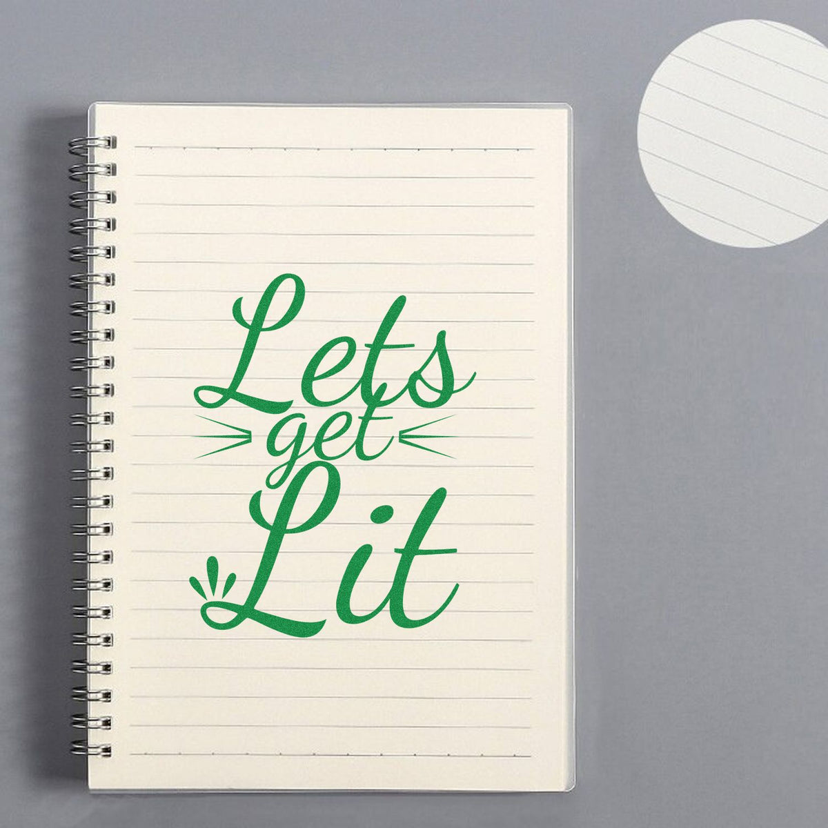 Green Lets get Lit stamp and round seal on cream lined spiral notebook, with matching seal impression.