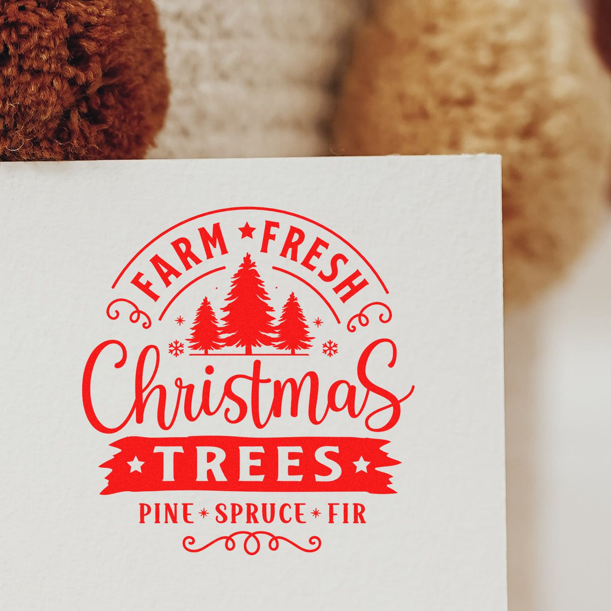 Red farm-fresh Christmas tree stamp seal on white paper with pine, spruce, and fir text and tree graphics.