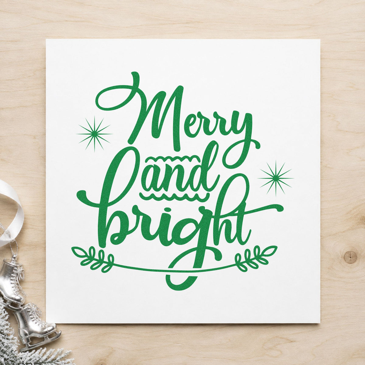 Merry And Bright Flourish craft stamp imprint in green ink on a handmade project, one idea being foil look gift tags.