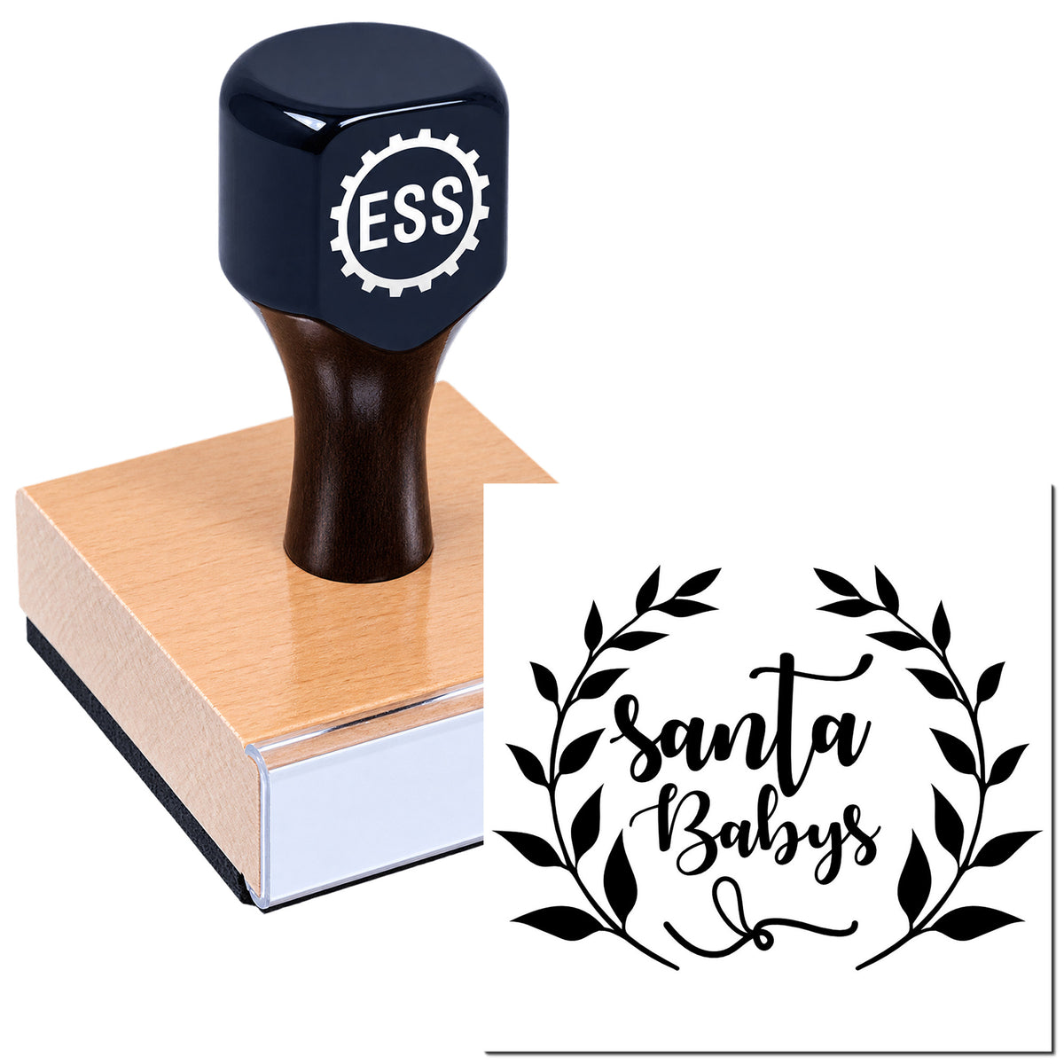Black ESS rubber stamp on wooden block with Santa Babys seal design, featuring a black leafy wreath on white background.