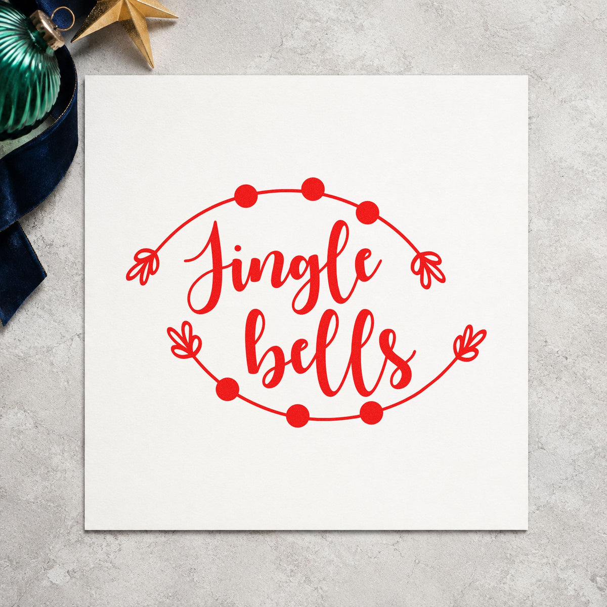 Jingle Bells Round Branch Frame craft stamp in red ink on cardstock, an easy option for coaster cloth printing.