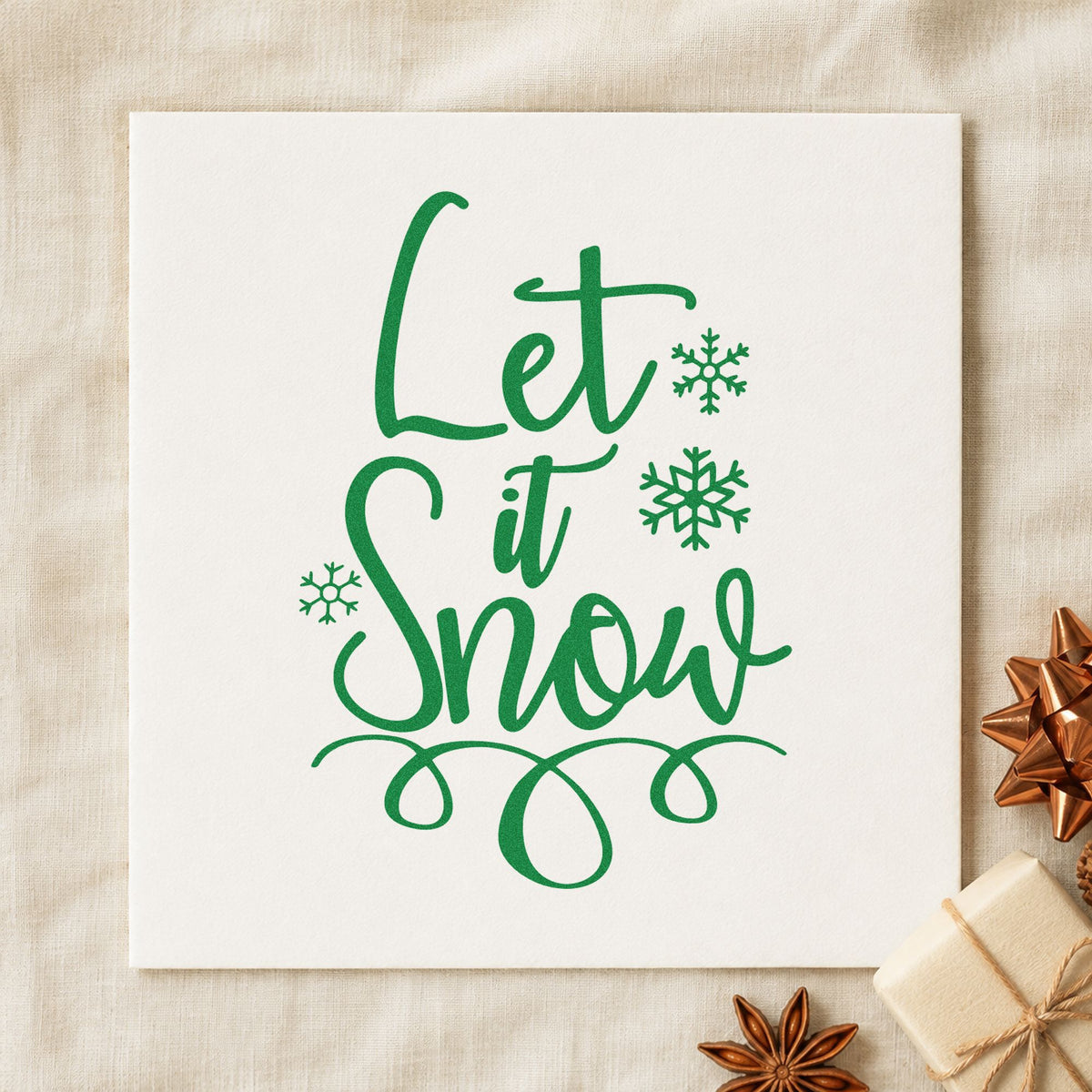 Let It Snow Loop Flourish craft stamp imprint in green ink on a handmade project, one idea being route client tags.