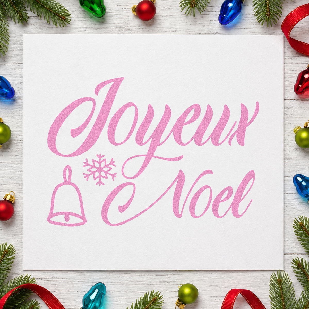 Joyeux Noel Bell Snowflake craft stamp in purple ink on cardstock, an easy option for travel album page.