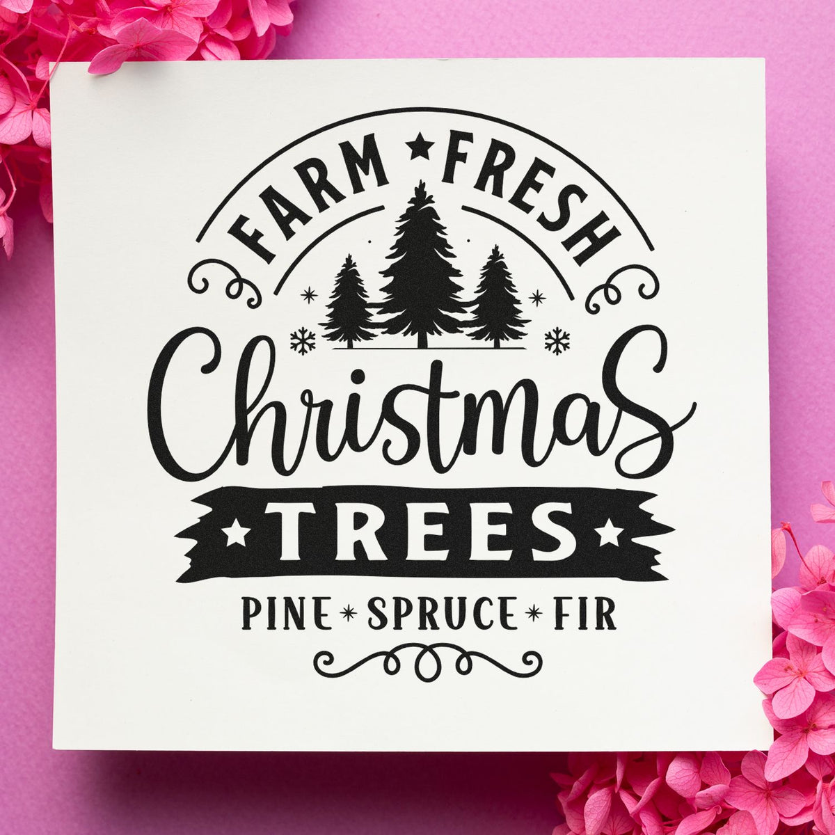Black farm-fresh Christmas tree stamp seal with pine, spruce and fir on white, surrounded by pink flowers.