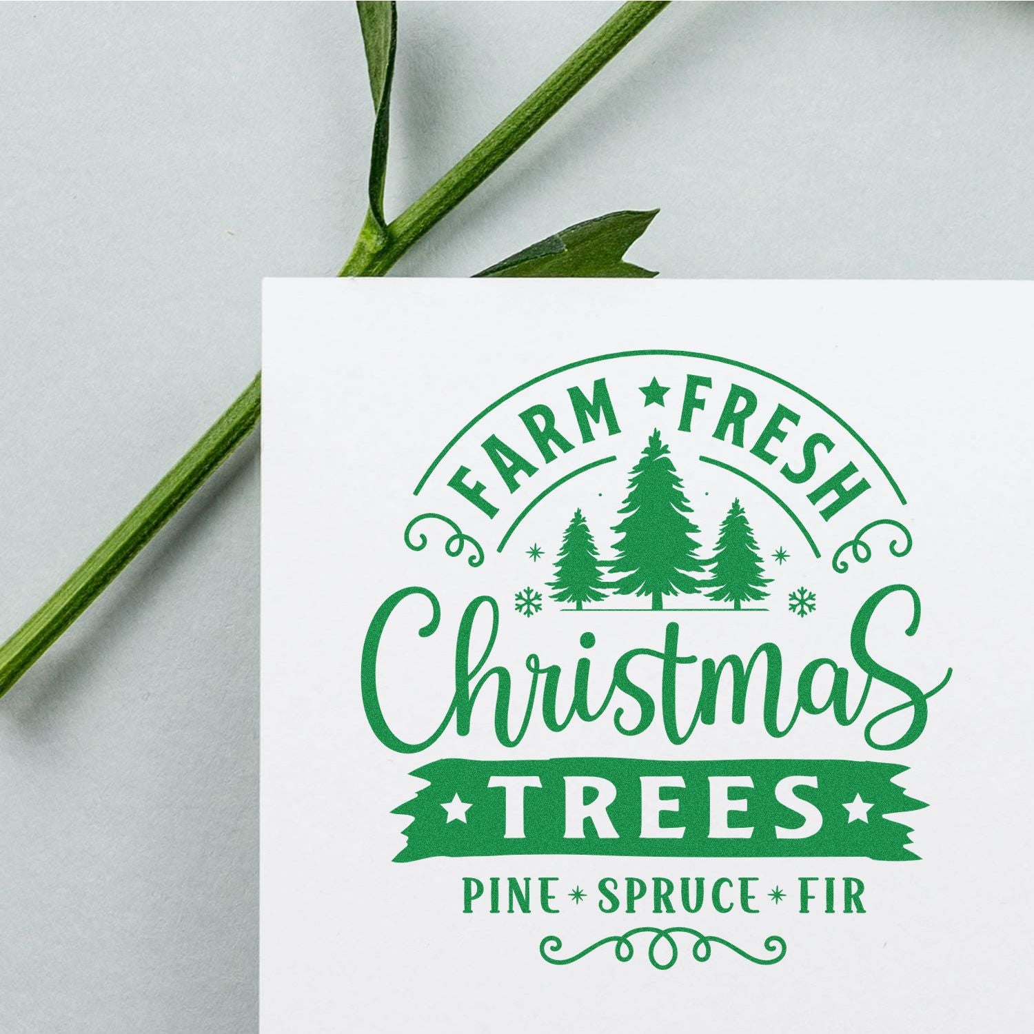 Green Christmas stamp seal on white card, featuring pine trees and Farm Fresh Christmas Trees with Pine Spruce Fir text.