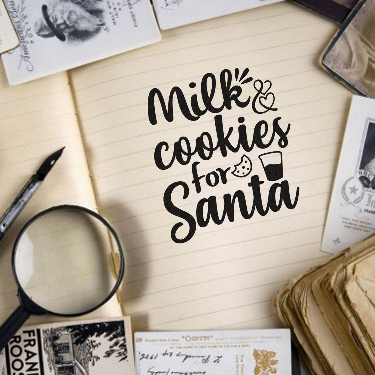 Black Milk & Cookies for Santa custom stamp with cookie and milk icons on cream notebook, surrounded by vintage stamp and seal samples.