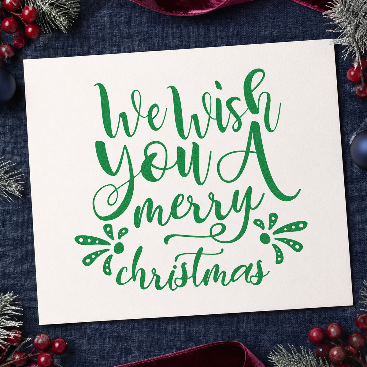 We Wish Merry Christmas craft stamp imprint in green ink on a handmade project, one idea being photo print tags.
