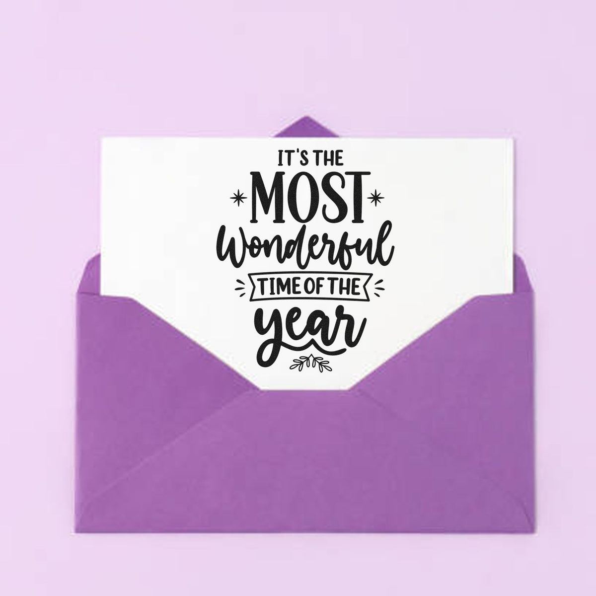 Purple stamp and seal with a white card reading Its the most wonderful time of the year in black script.