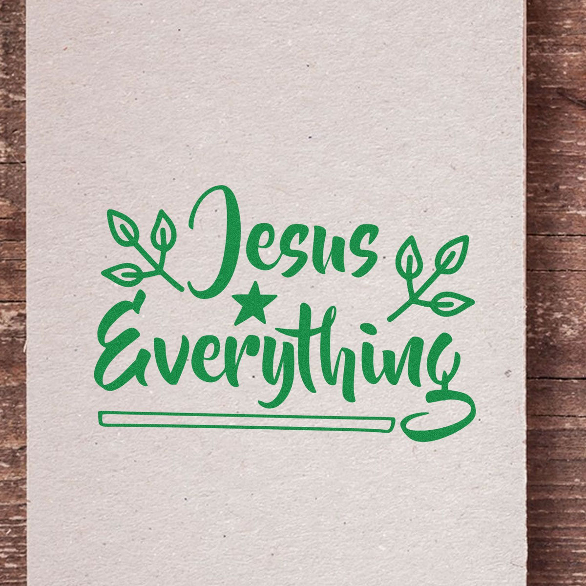 Green Jesus Everything stamp and seal design with leafy accents, star, and underline on beige paper.