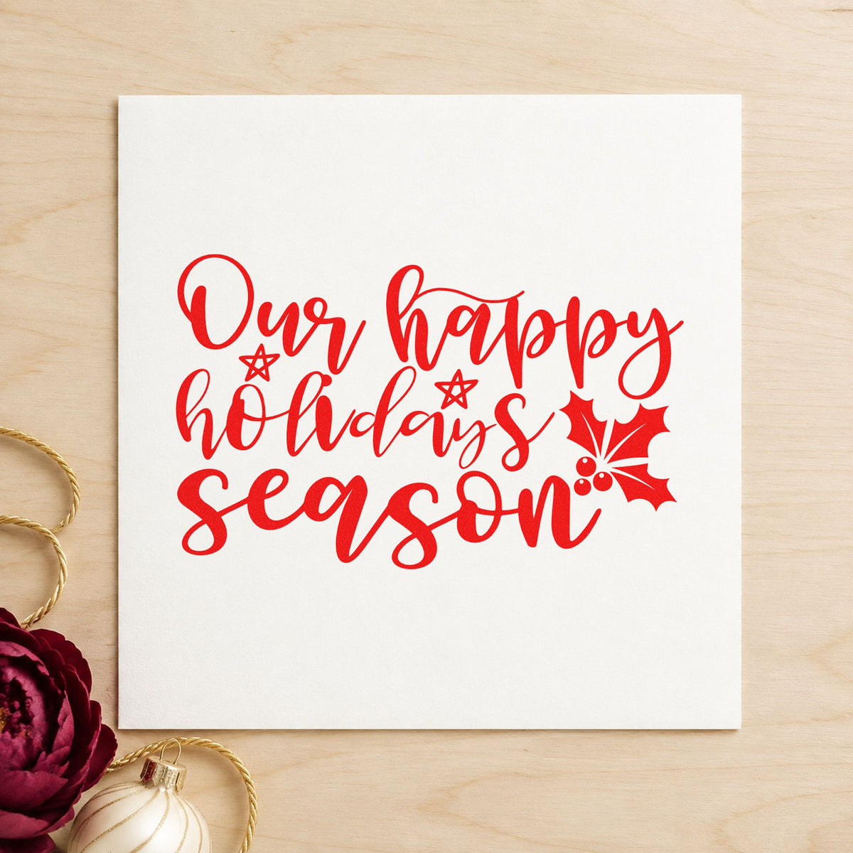 Our Happy Holidays Season craft stamp in red ink on cardstock, an easy option for table cloth printing.