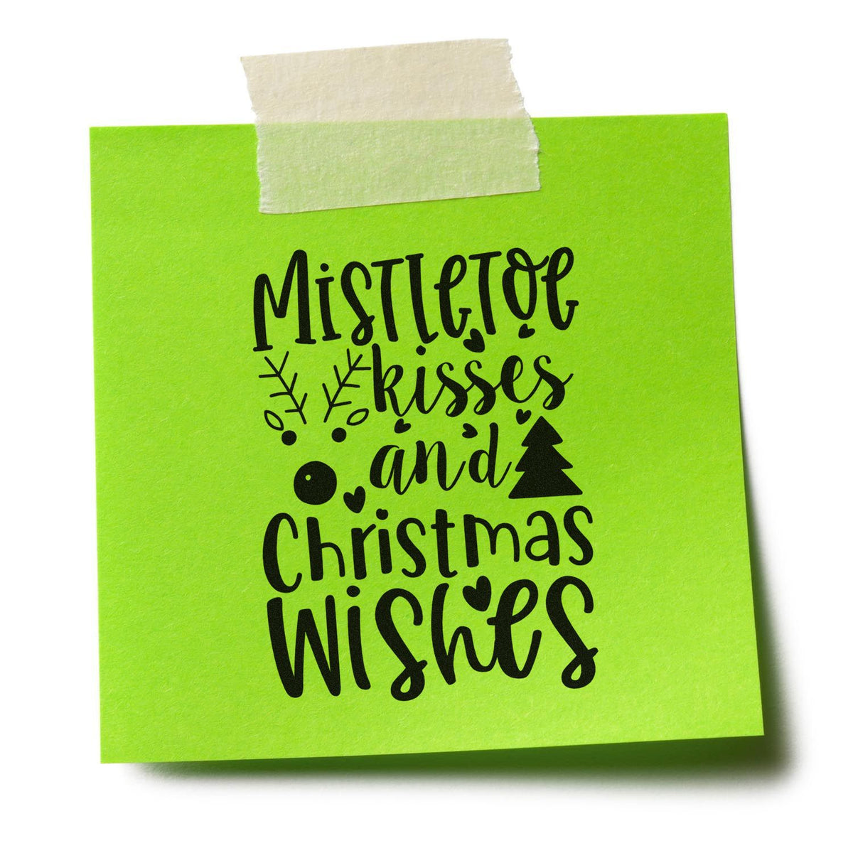 Bright green sticky note with black holiday stamp design reading Mistletoe kisses and Christmas wishes, taped at top.