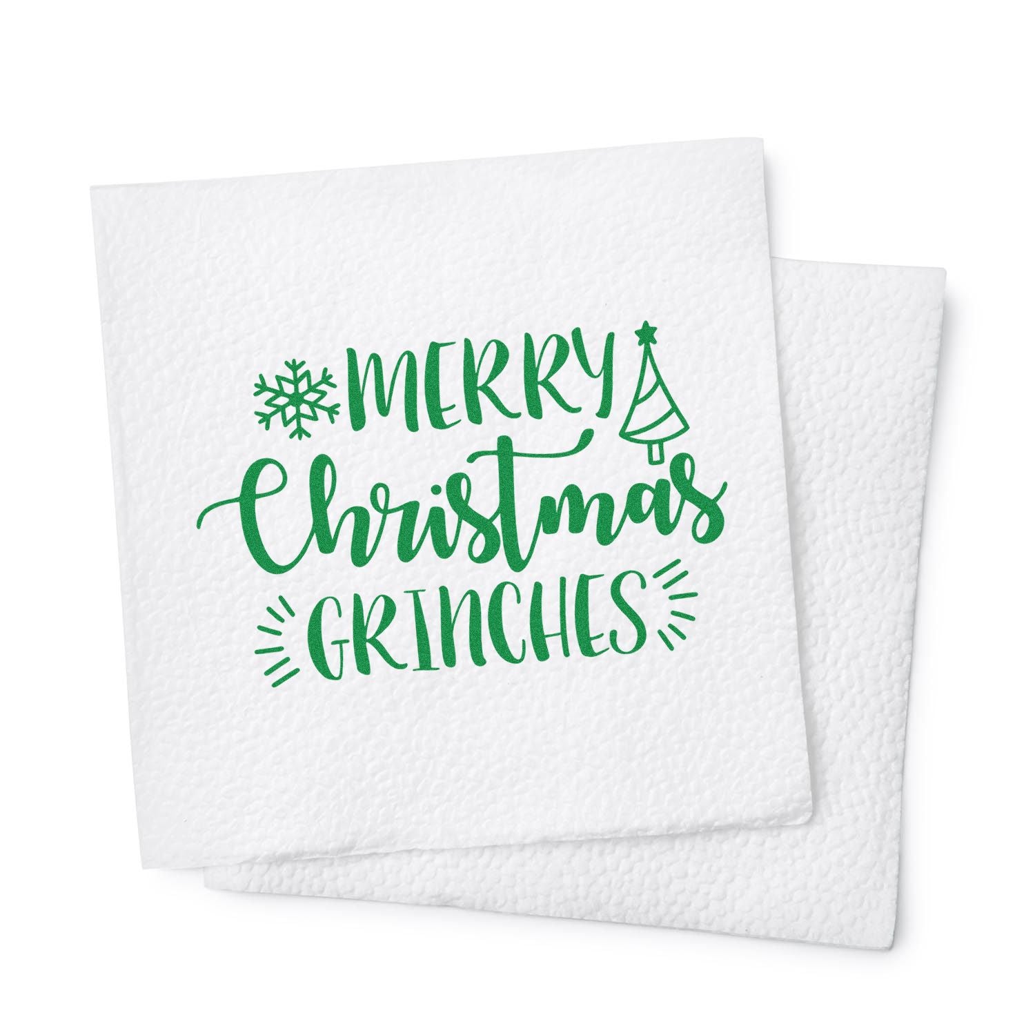White textured stamp and seal napkins with green Merry Christmas Grinches lettering, snowflake, and tree icon.