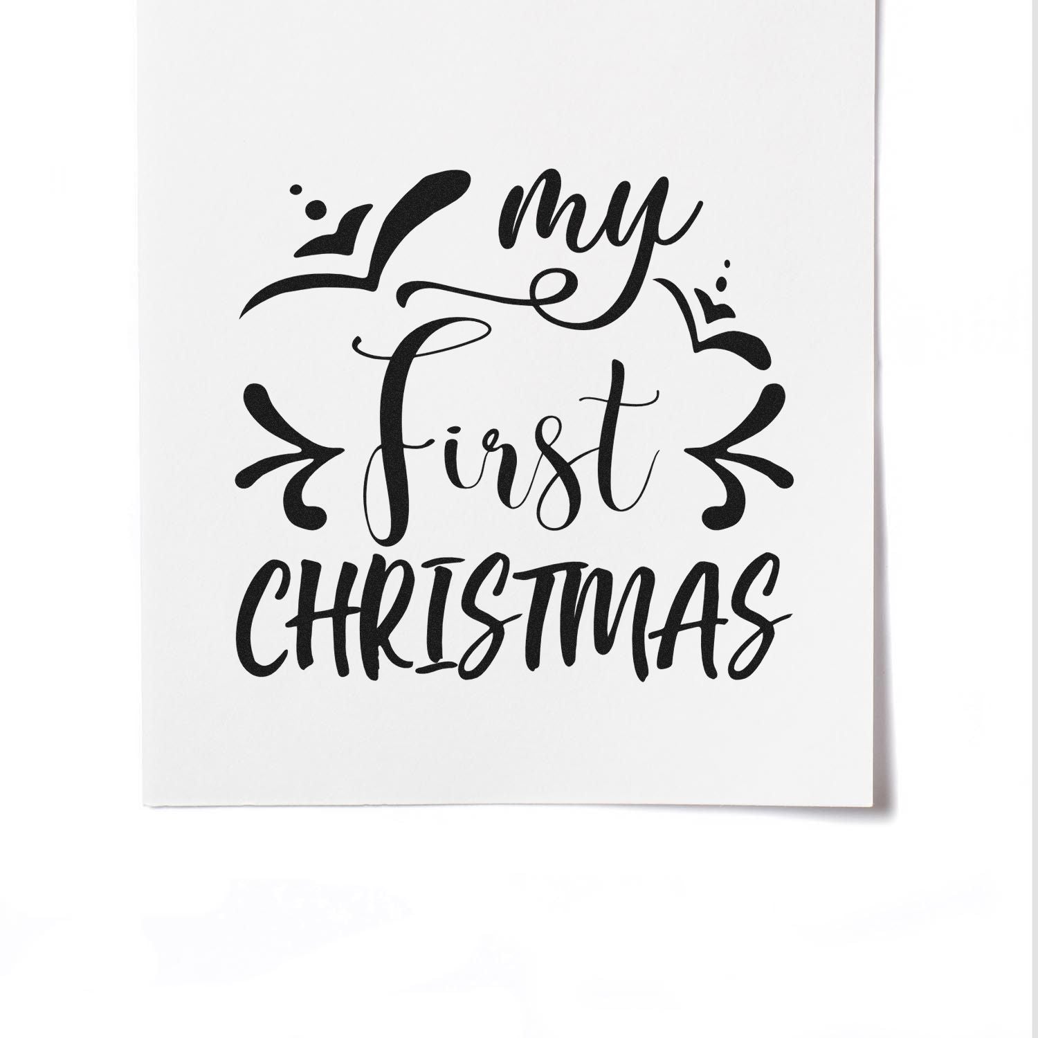 Black my first Christmas stamp seal design with decorative flourishes on a white background.