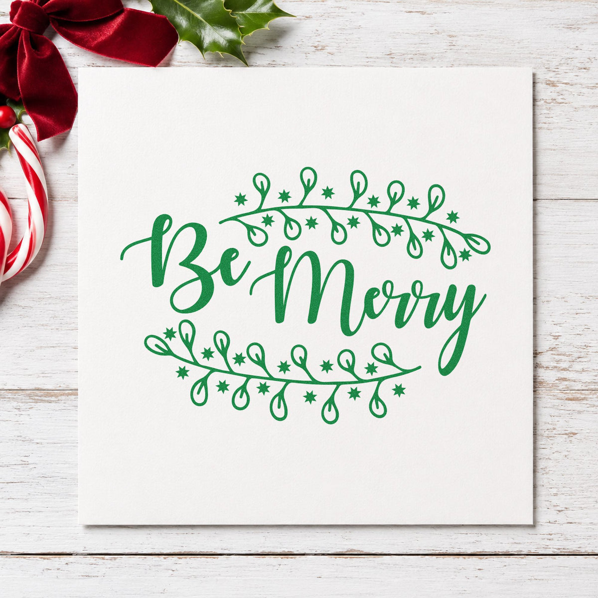 Be Merry Botanical Border craft stamp imprint in green ink on a handmade project, one idea being nursery shelf cards.