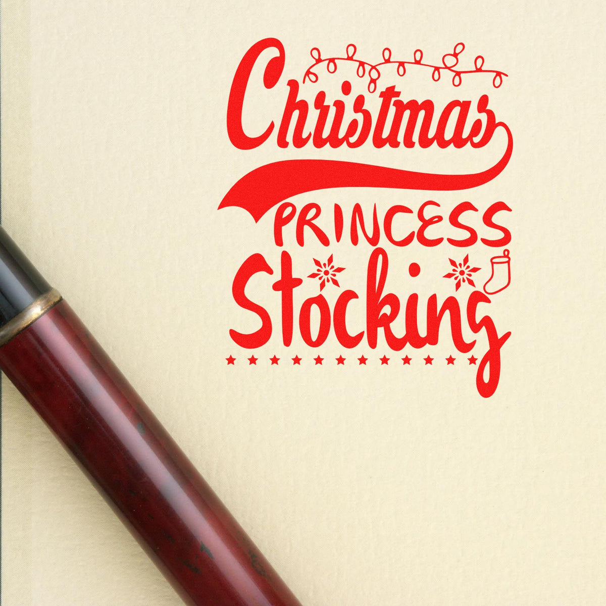 Red Christmas Princess Stocking stamp with string lights on cream paper, shown beside a burgundy seal handle.