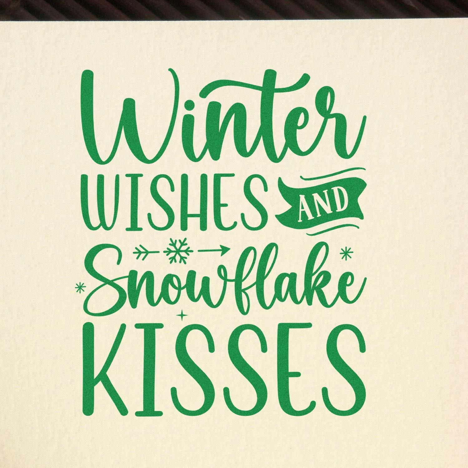 Green winter wishes and snowflake kisses stamp and seal design in green on a cream background