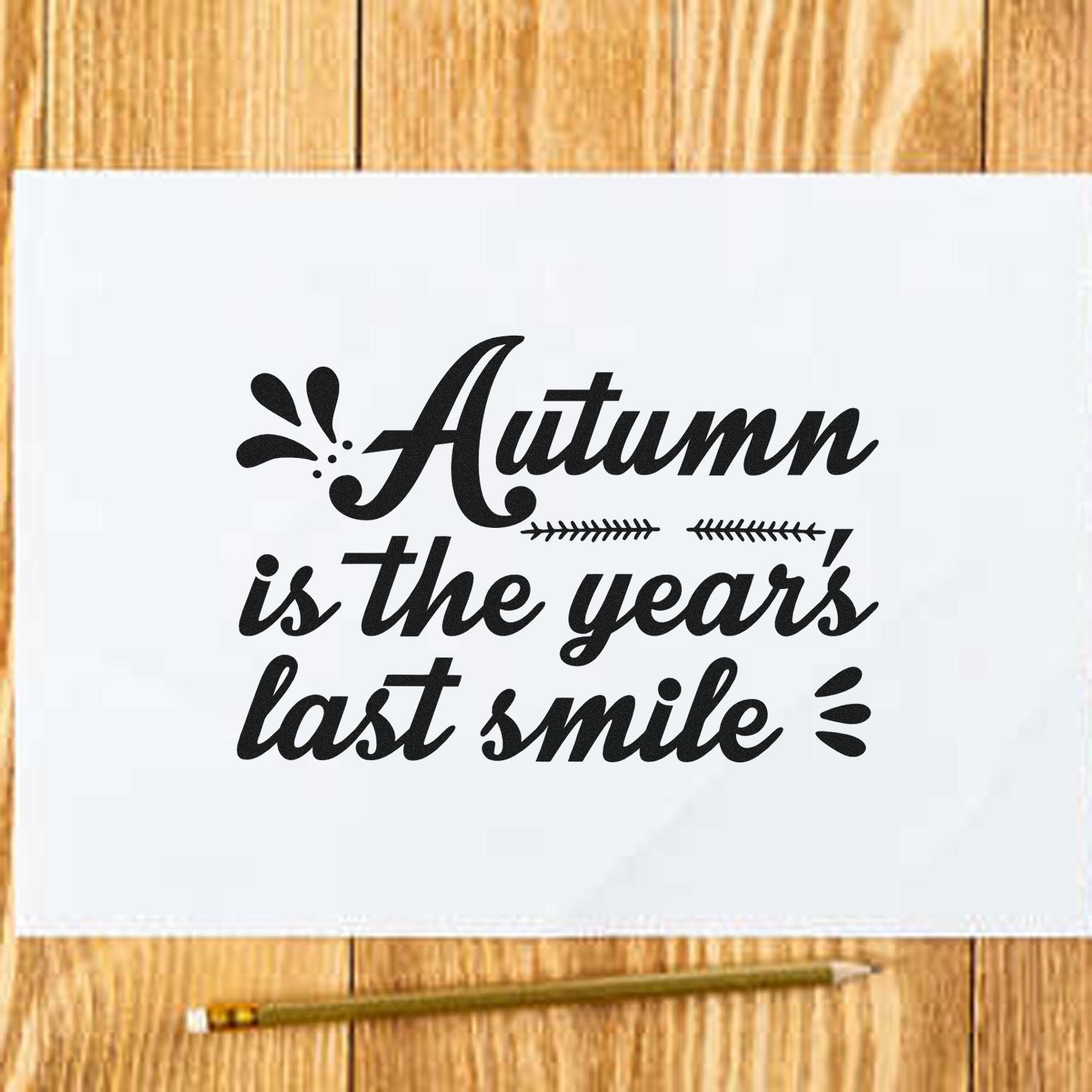 Black autumn stamp and seal design reading Autumn is the year's last smile, with leaf accents on white paper.