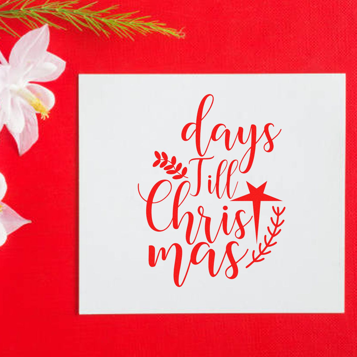 Red Christmas stamp and seal design with script text, star and leaf accents on white square against a bright red background.