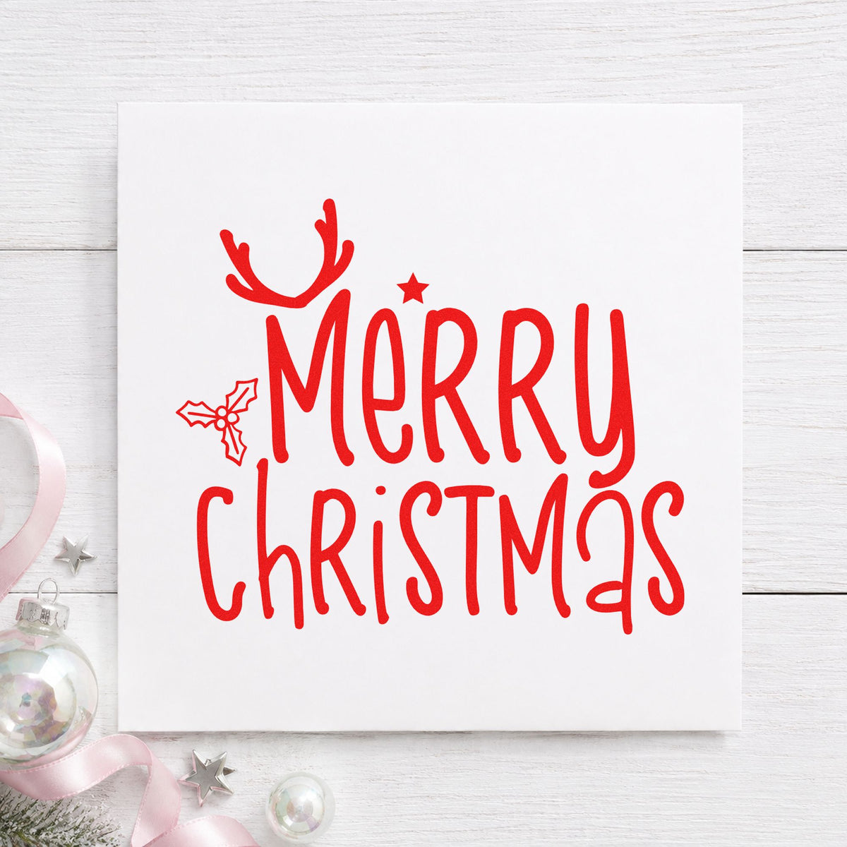 Merry Christmas Antlers Holly craft stamp in red ink on cardstock, an easy option for napkin edge printing.
