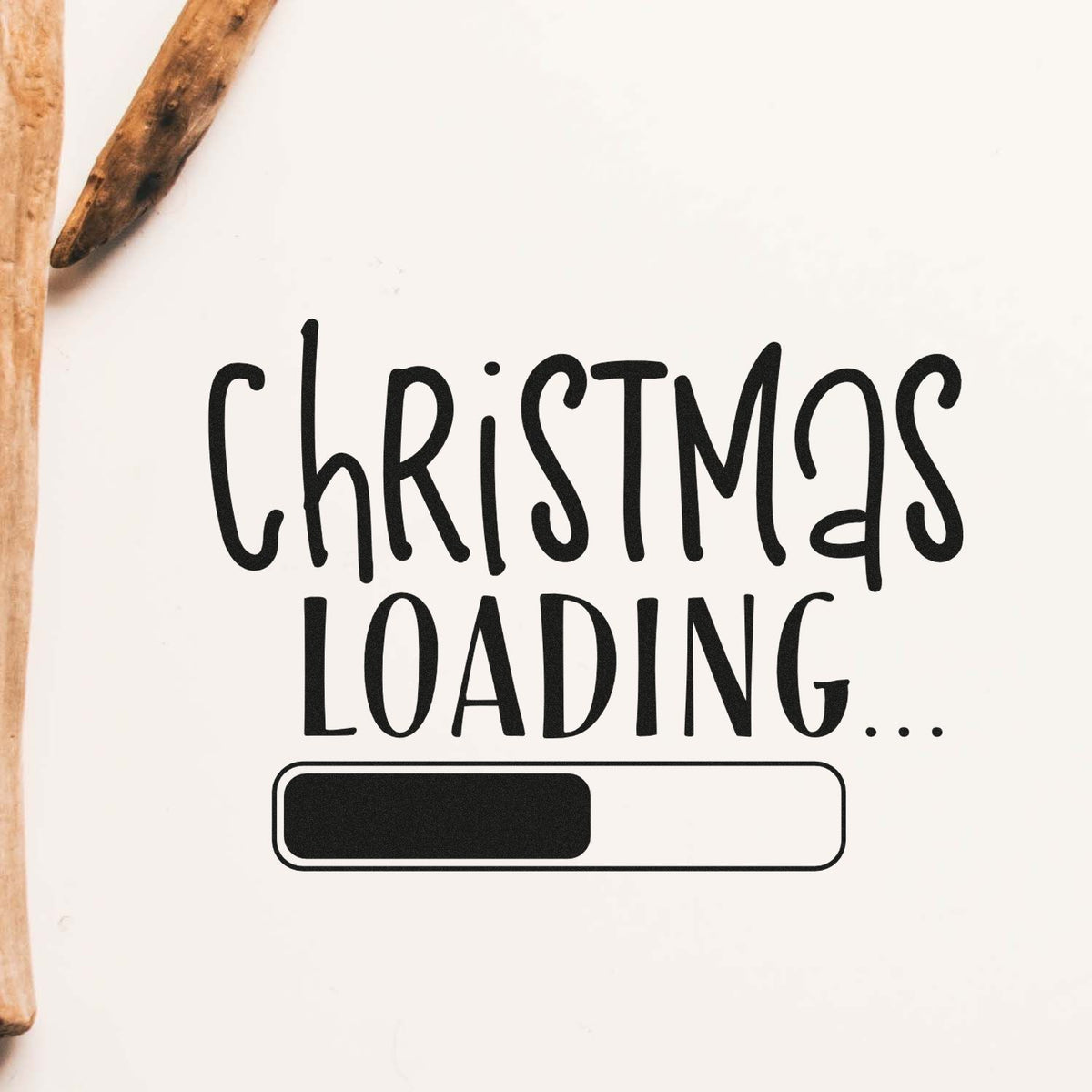 Wooden stamp and seal with black Christmas loading... text and progress bar on a white background.