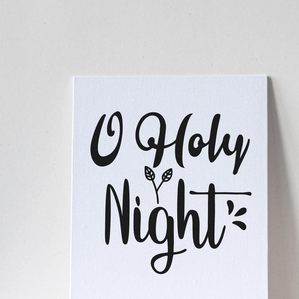 Black Oh Holy Night holiday stamp/seal on white textured card, with leafy accent and bold script.