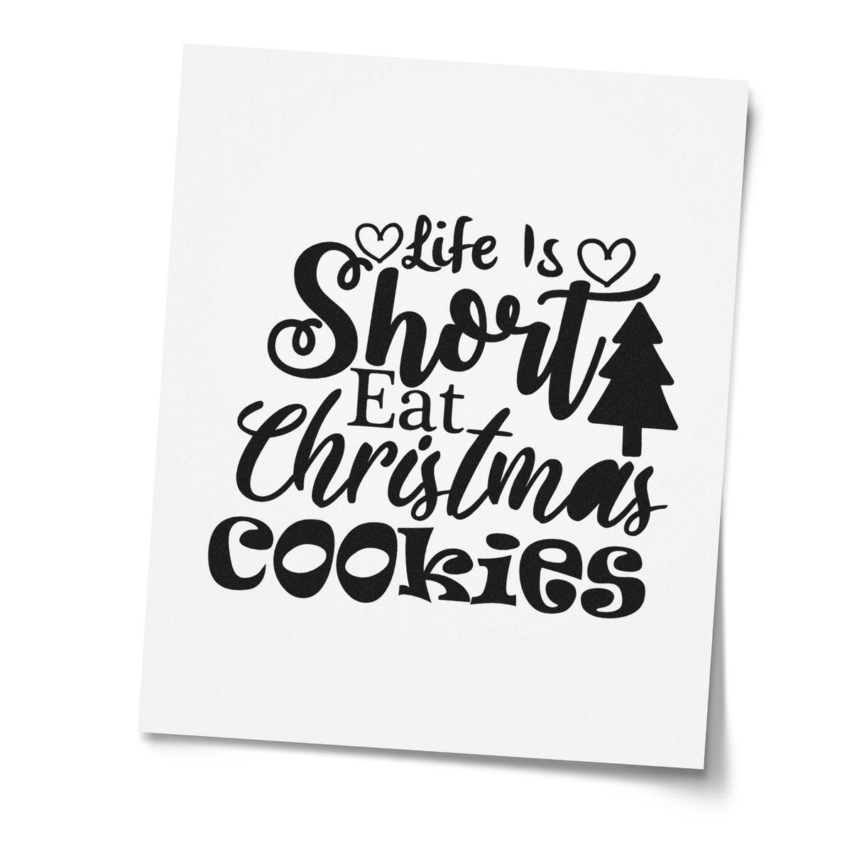 Black stamp and seal design on white paper reading Life Is Short Eat Christmas Cookies with hearts and a Christmas tree.