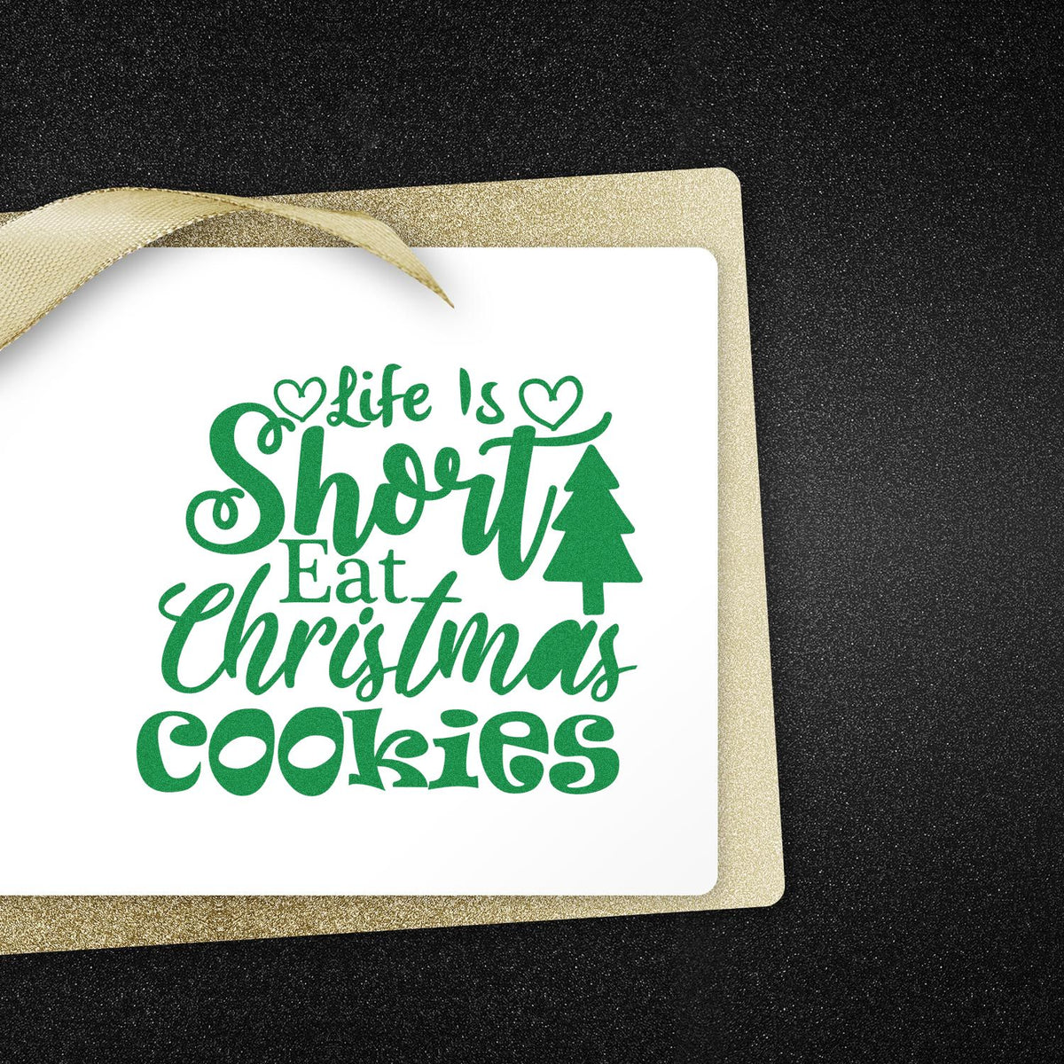 Green Christmas stamp reading Life Is Short Eat Christmas Cookies on a white card with gold glitter seal and ribbon.