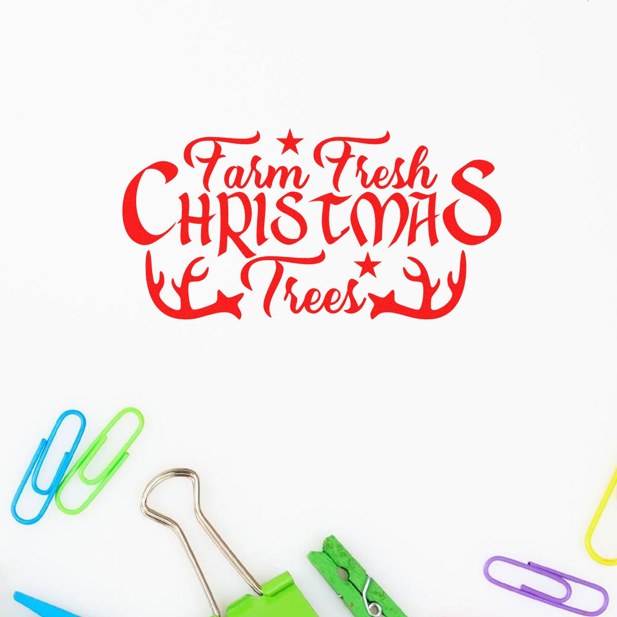 Red Farm Fresh Christmas Trees stamp seal in bright red with stars and antlers on a white background, surrounded by colorful paper clips.