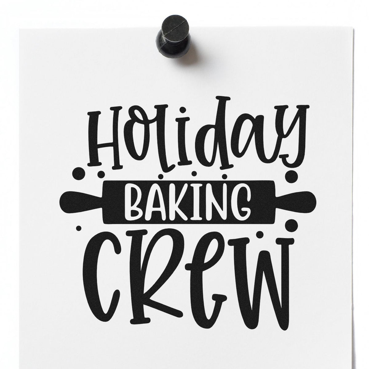 Black rubber stamp seal on white paper with Holiday Baking Crew and rolling pin graphic.