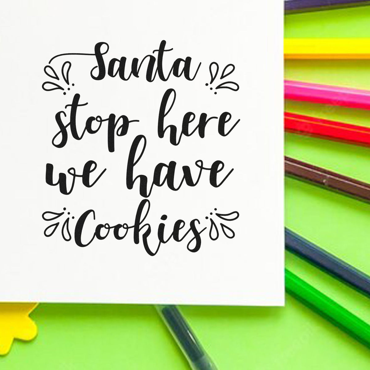 Black Santa stop here we have cookies stamp on white card, with neon green background and colorful pens