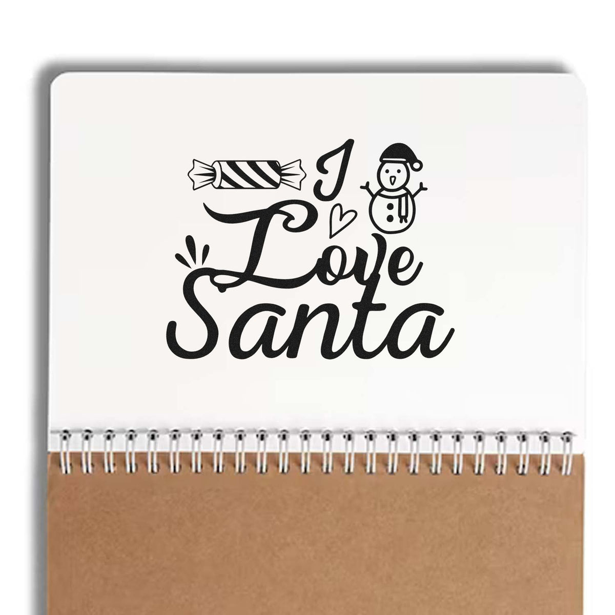 Black I Love Santa holiday stamp design with candy and snowman on white seal pad, brown kraft cover
