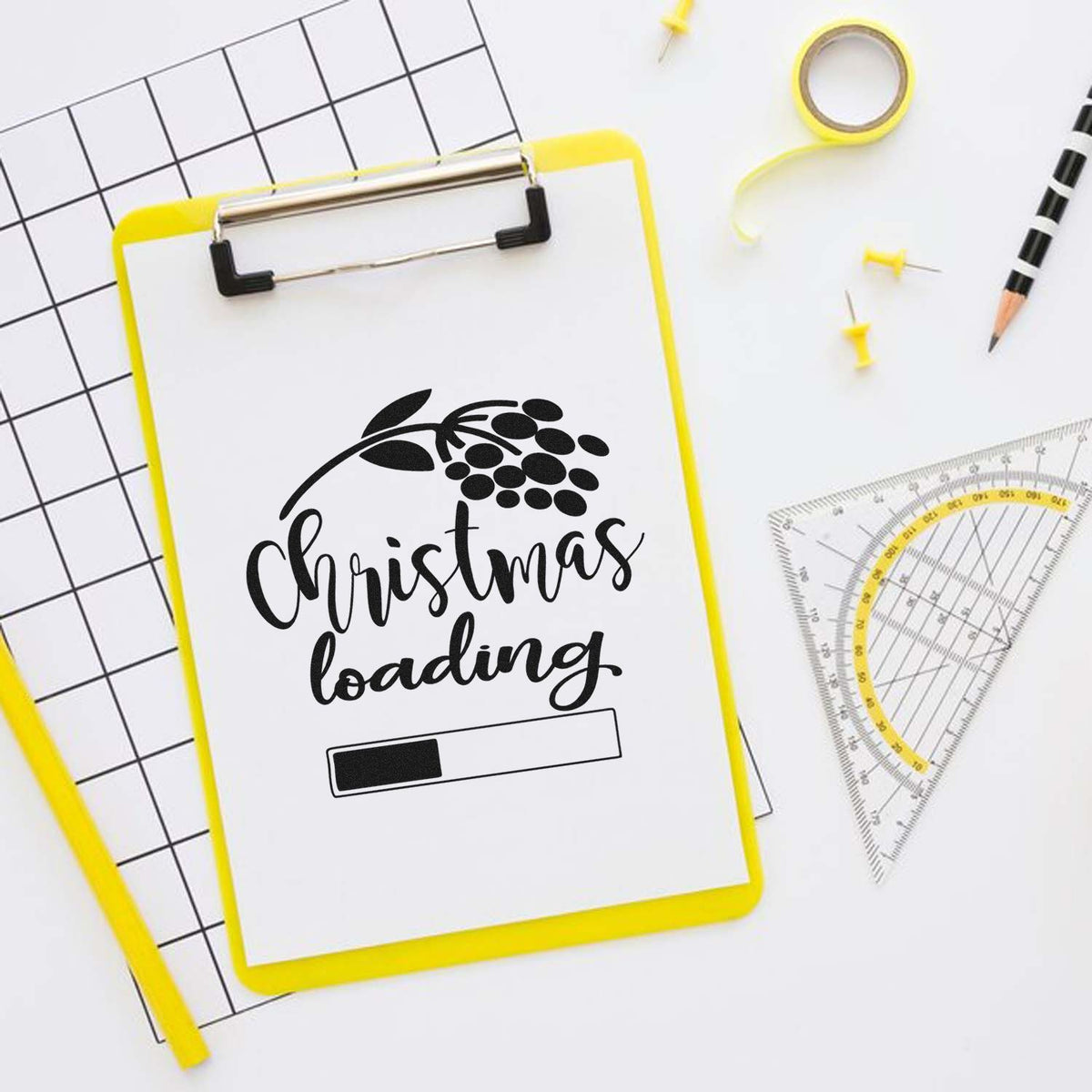Yellow clipboard stamp seal with black Christmas loading design, progress bar, and floral accent on white background.