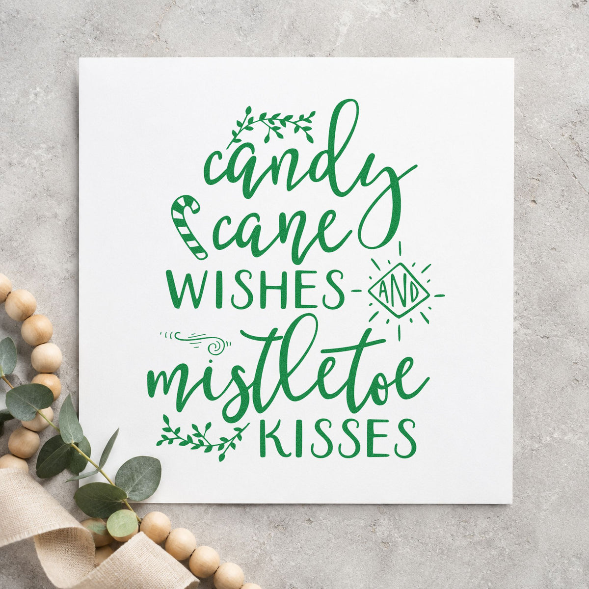 Candy Cane Mistletoe Wishes craft stamp imprint in green ink on a handmade project, one idea being cane bundle tags.