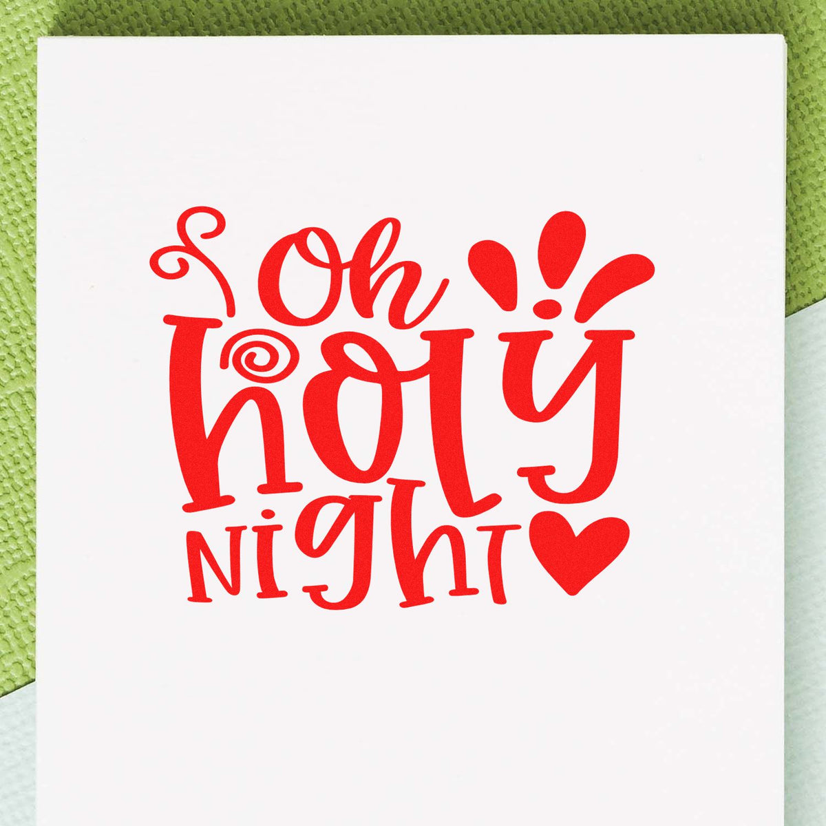 Red Oh Holy Night holiday stamp seal on white cardstock with heart and exclamation accents
