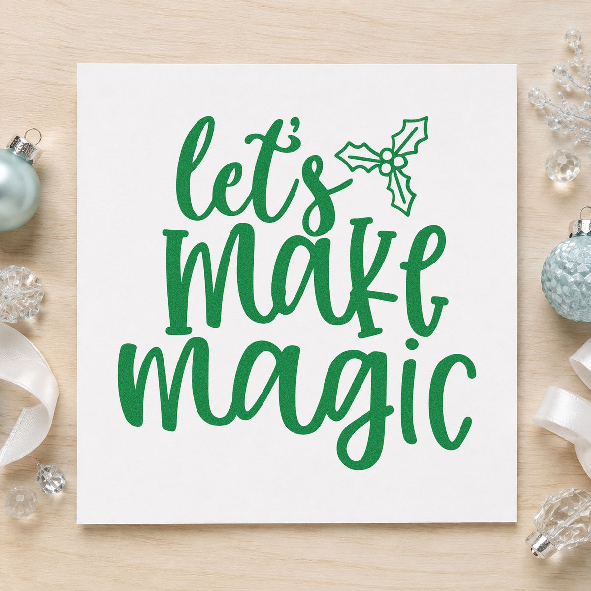 Let's Make Magic Holly craft stamp imprint in green ink on a handmade project, one idea being craft kit gift tags.