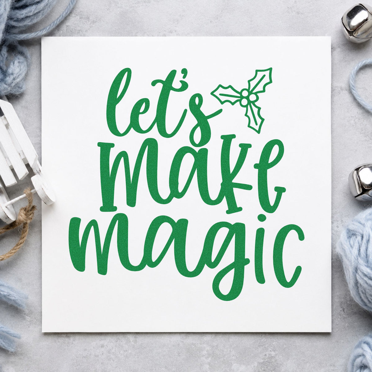 Let's Make Magic Holly craft stamp imprinted in green ink on paper, a design suited to framed studio door.