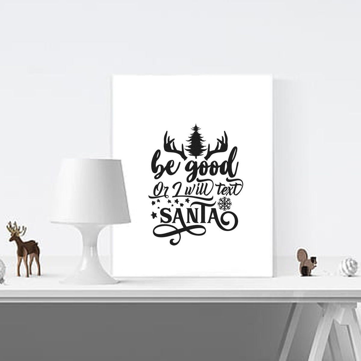 Black holiday stamp/seal design on white canvas with antlers, pine tree, snowflakes, stars, and be good or I will text SANTA.