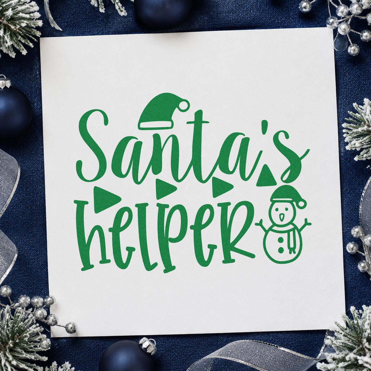 Santa's Helper Snowman craft stamp imprint in green ink on a handmade project, one idea being geometric gift tags.