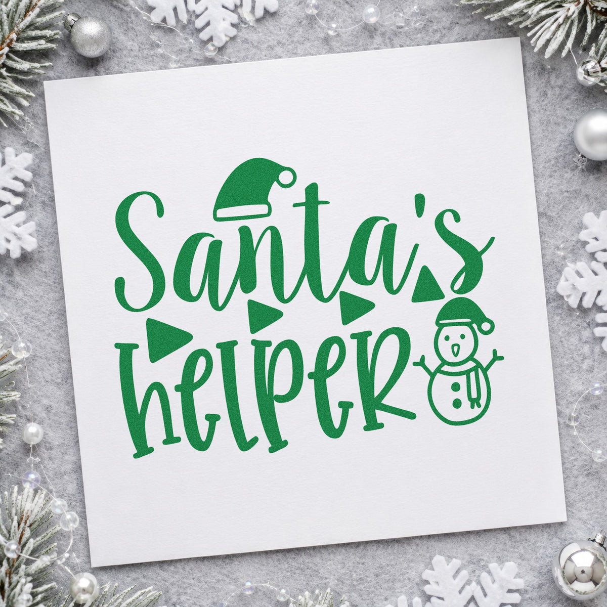Santa's Helper Snowman craft stamp imprint in green ink on a handmade project, one idea being modern table cards.