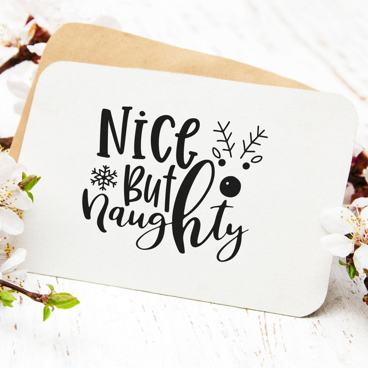 Black Nice but Naughty custom stamp and seal on white card with tan backing and floral accents