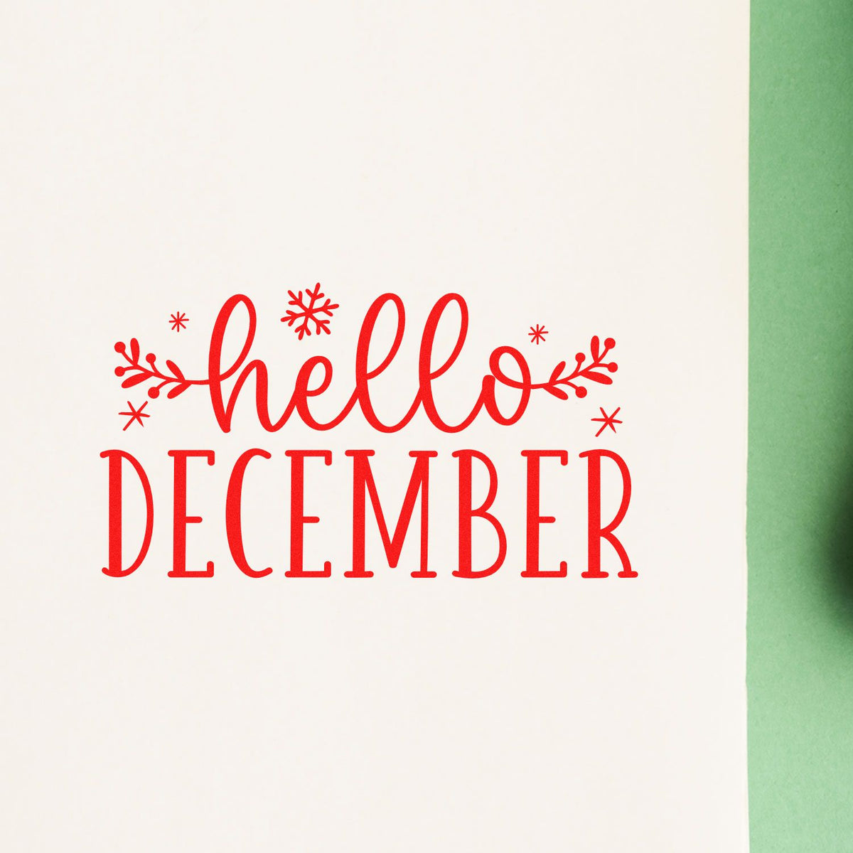 Red hello December holiday stamp and seal with snowflakes on white paper, green edge.