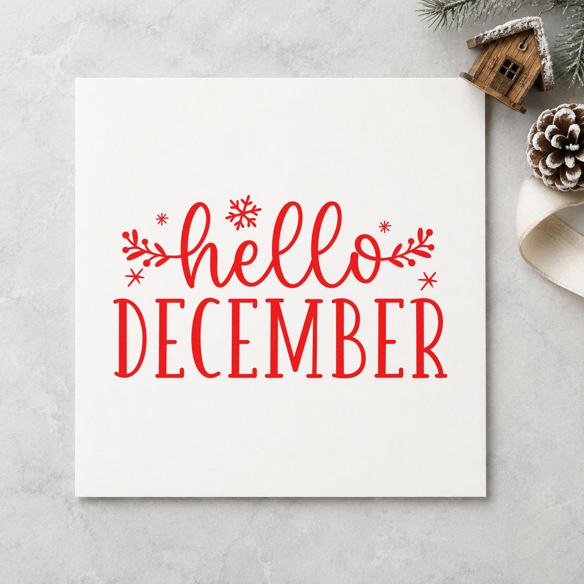 Hello December Sprigs craft stamp in red ink on cardstock, an easy option for calendar cloth printing.