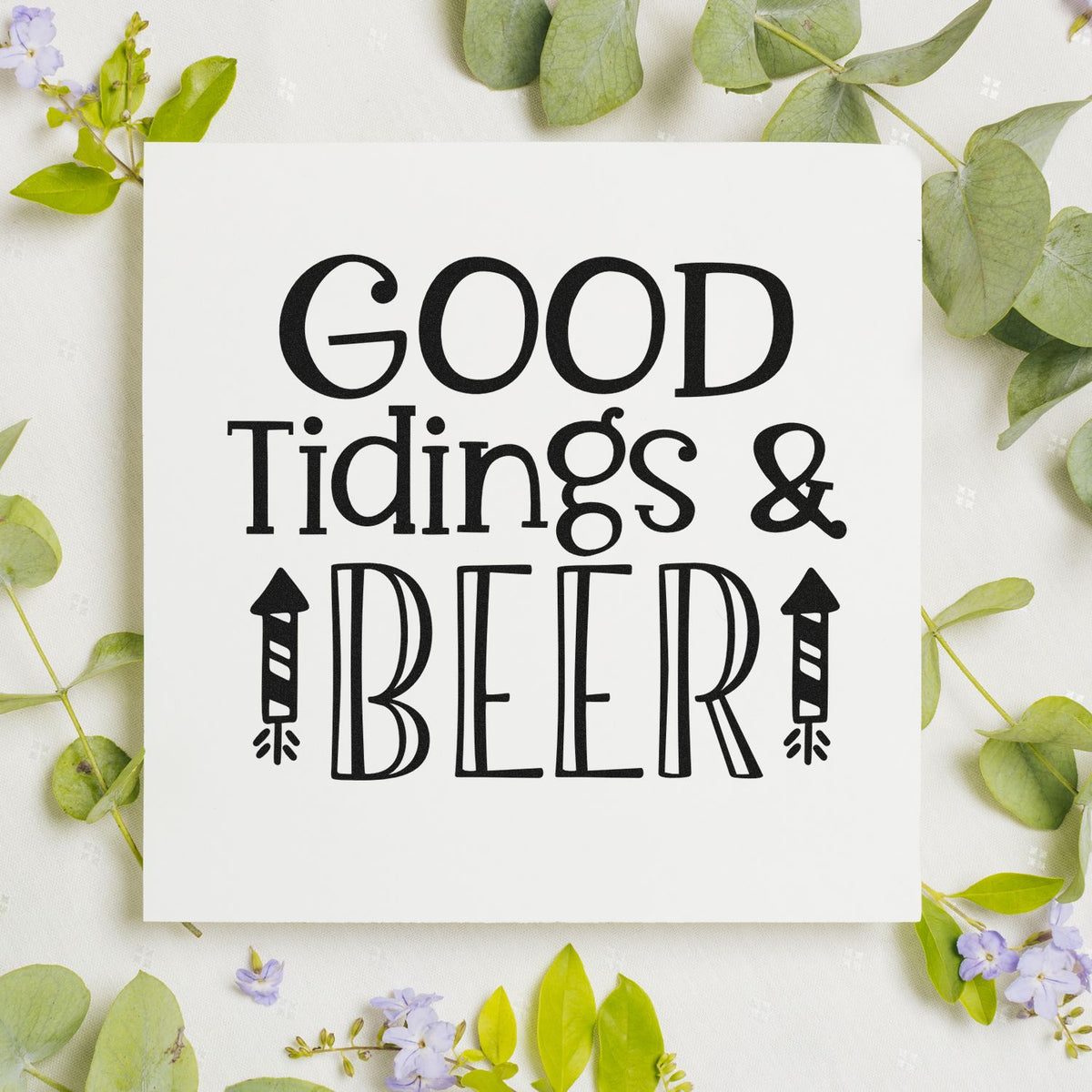 Custom stamp and seal design reading Good Tidings & Beer in black, with beer bottle icons on a white background and green leaves.