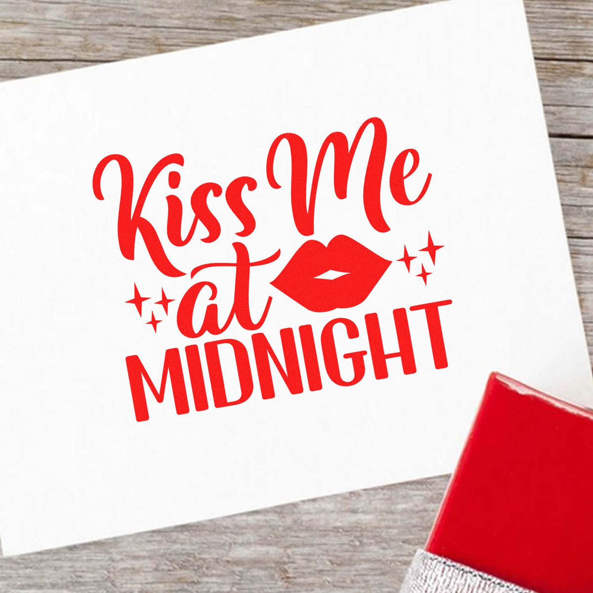 Red Kiss Me at Midnight stamp design with lips and sparkles on white paper, beside a red stamp seal block.