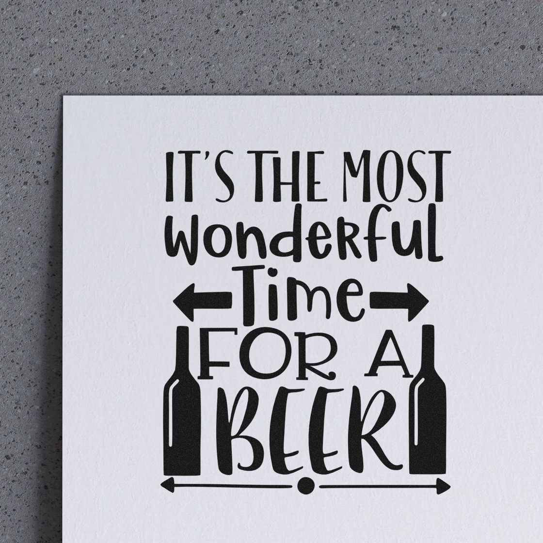 Black decorative stamp/seal on white paper reading Its the most wonderful time for a beer, with bottle icons and arrows.